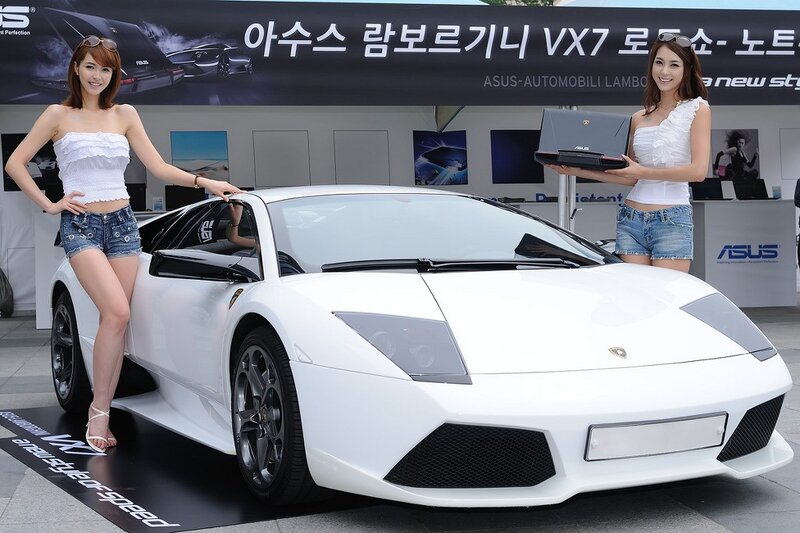 Women with white Lamborghini at event