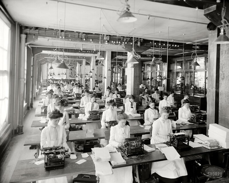 Women working at typewriters in office