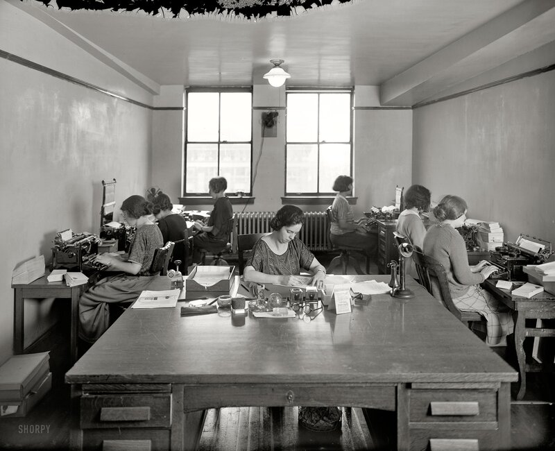 Women working at typewriters in office