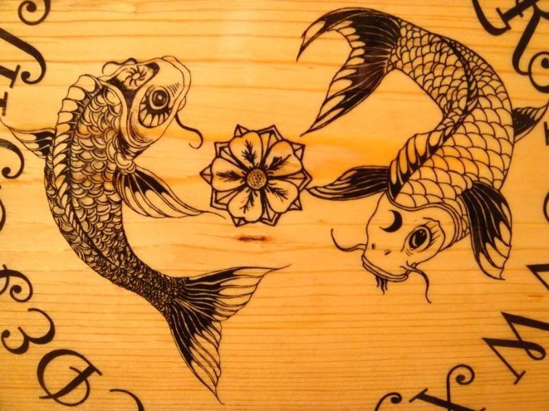 Wood-burned koi fish design