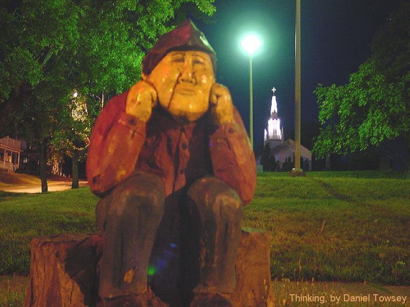 Wood carving of a thinker