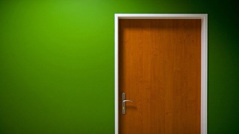 Wood door on green wall