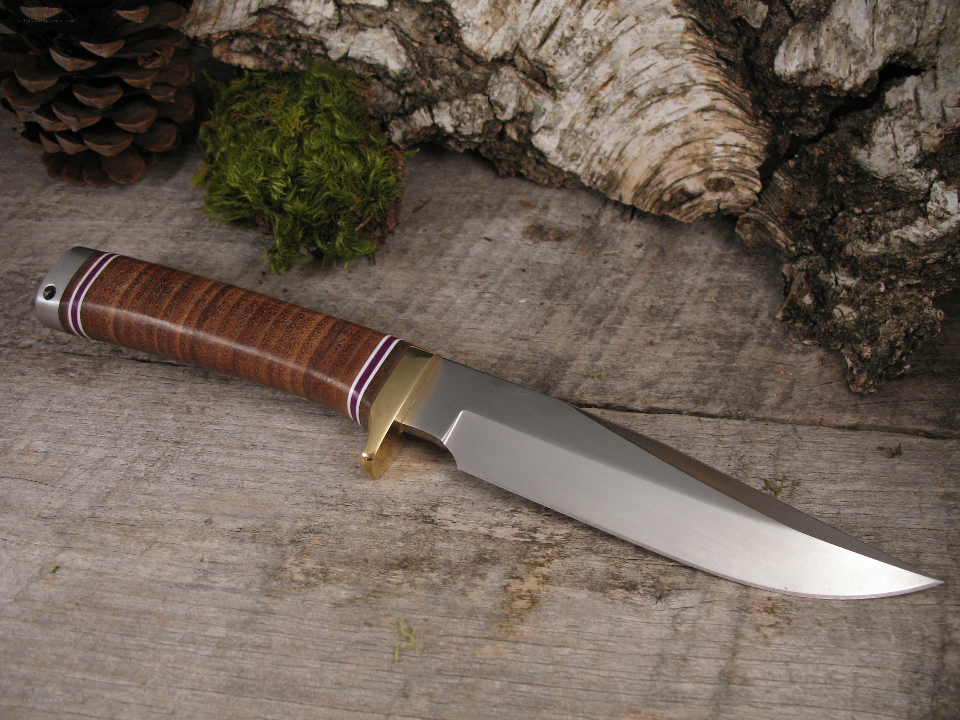 wood-handled knife on rustic surface