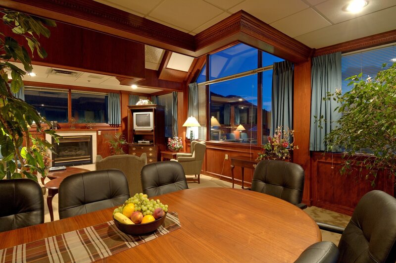 wood-paneled meeting room with fireplace
