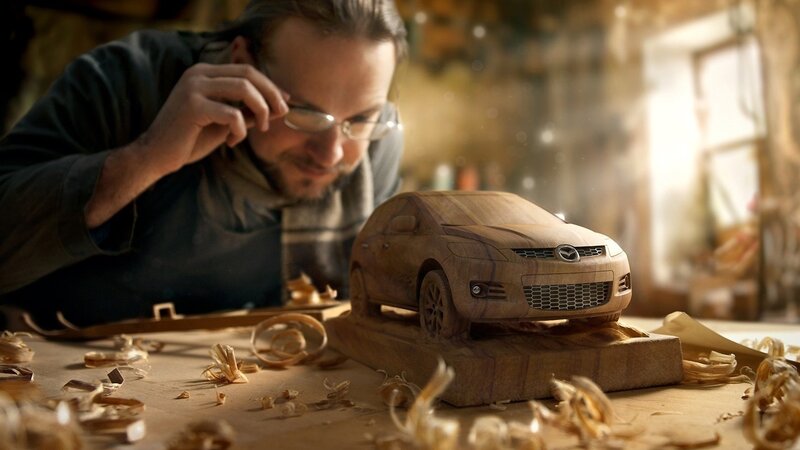 Woodcarver crafting a car model