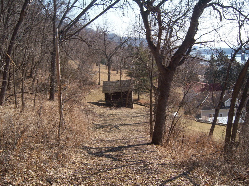 Wooded path with shed and houses