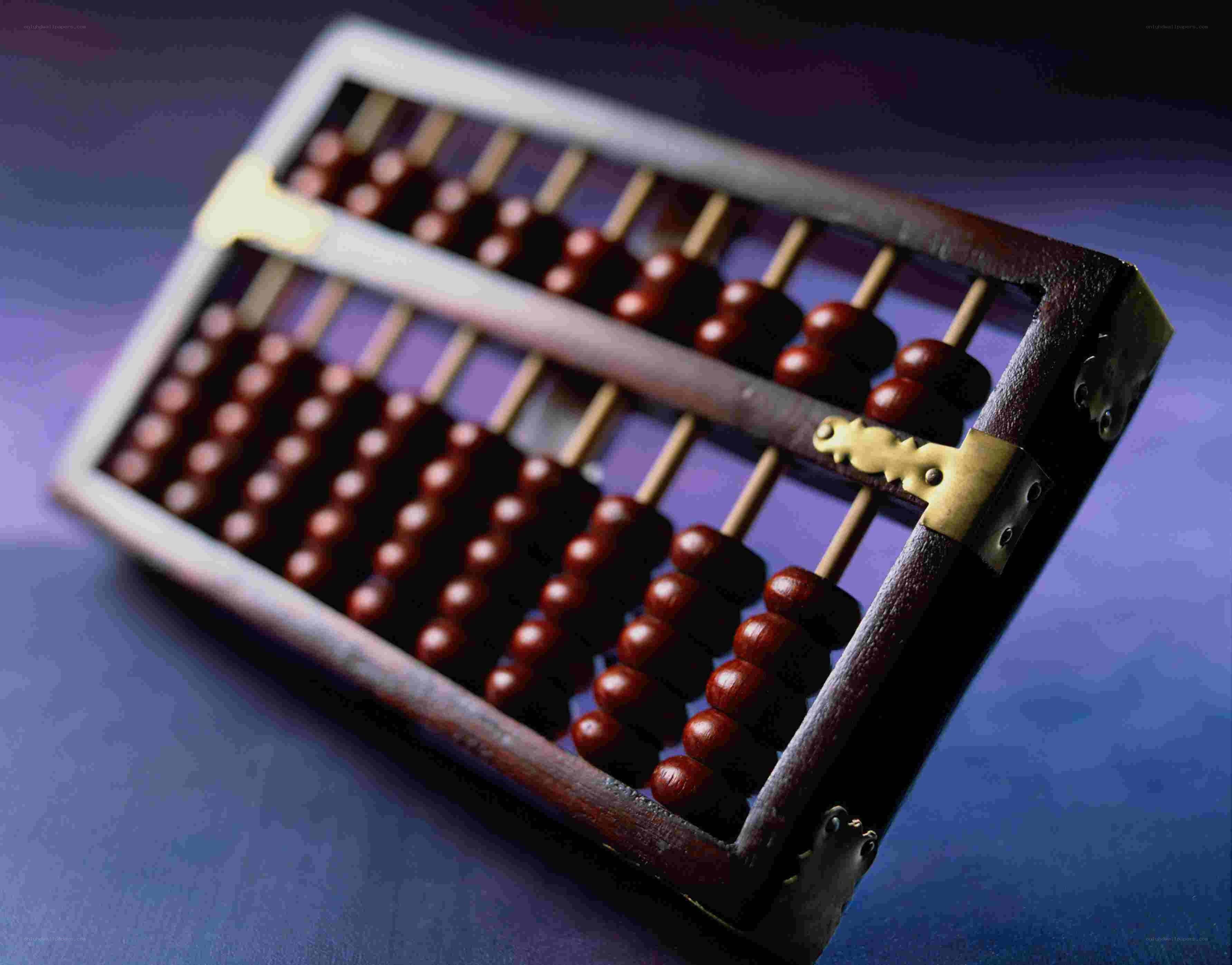 Wooden abacus on blue surface