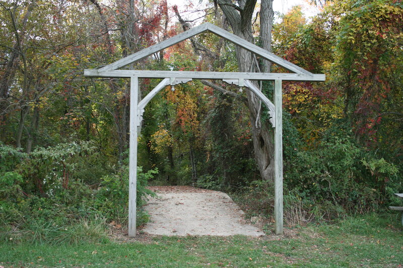 Wooden archway in autumn forest