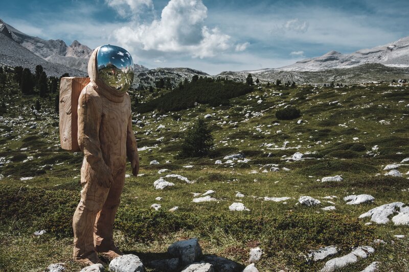 Wooden astronaut in mountains