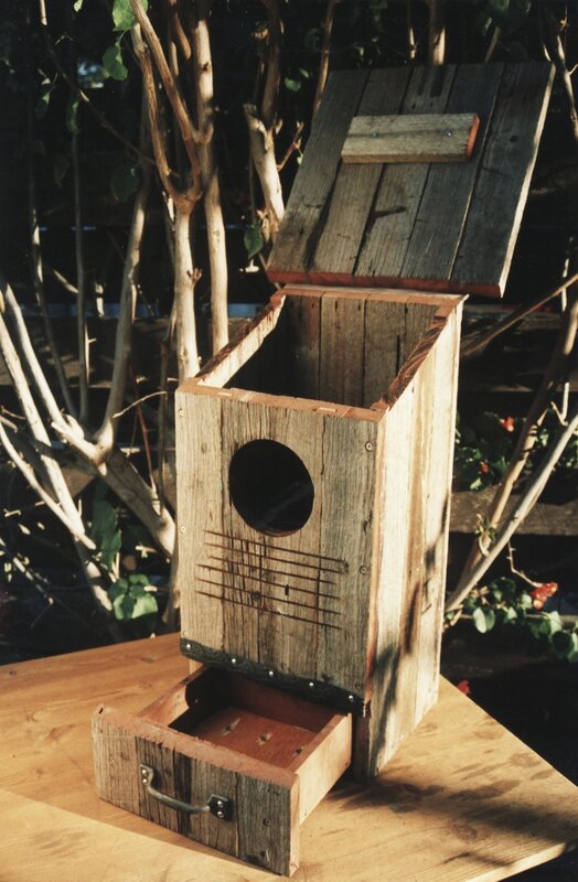 Wooden birdhouse with drawer