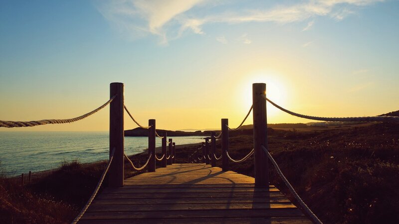 Wooden boardwalk at sunset