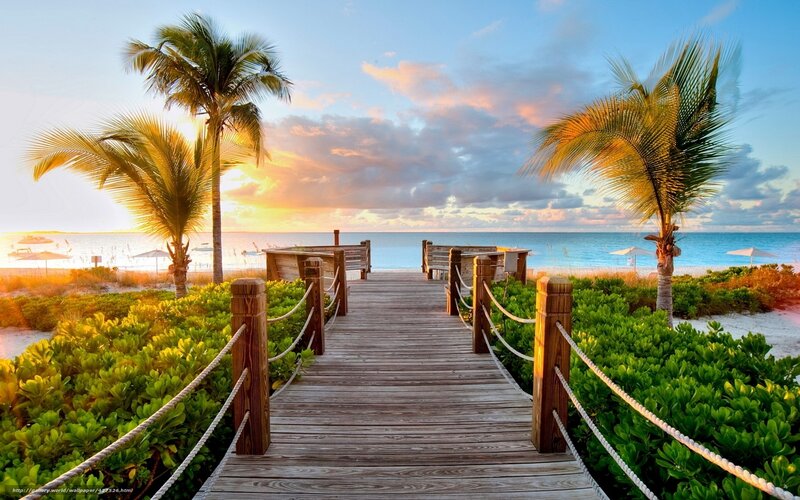 Wooden boardwalk to tropical beach
