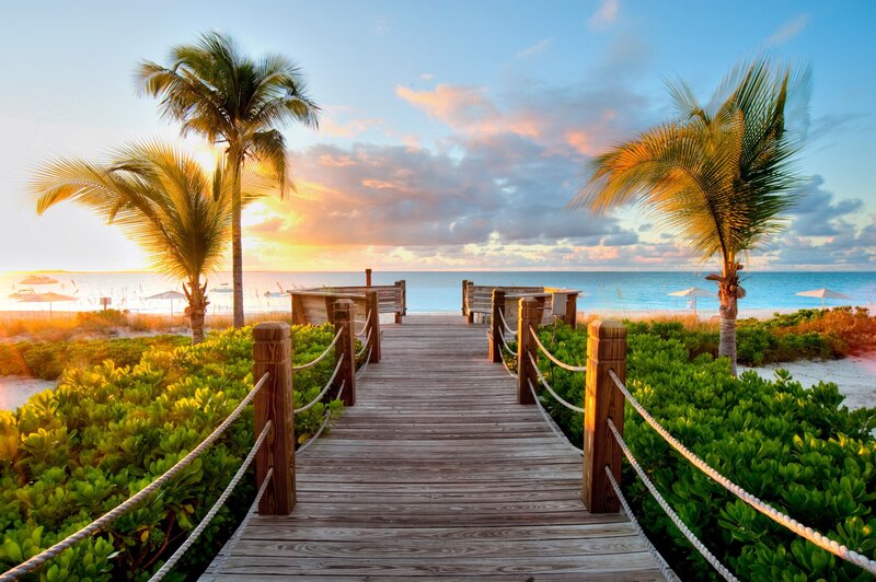 Wooden boardwalk to tropical beach