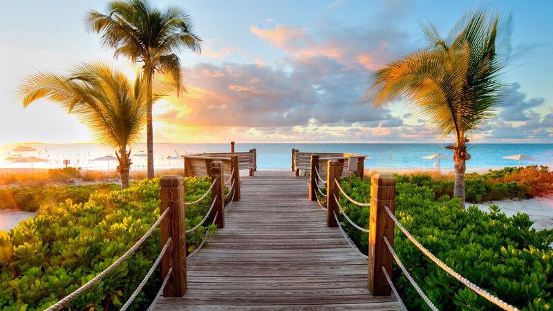 Wooden boardwalk to tropical beach