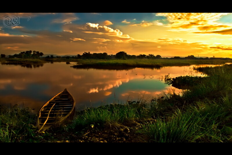 Wooden Boat on Riverbank — Orange