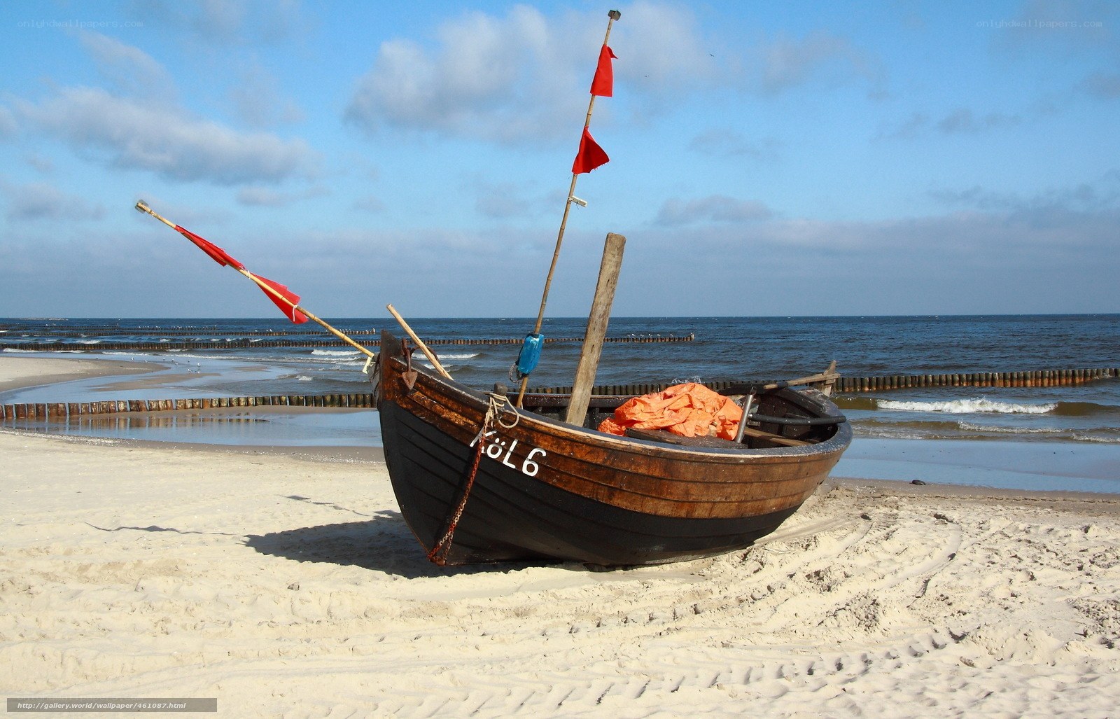 Wooden boat on sandy beach