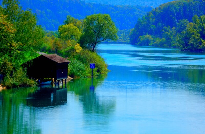 Wooden Boathouse on River — Blue