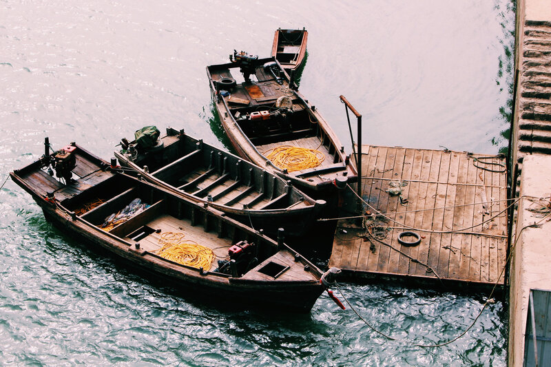 Wooden boats docked at a pier