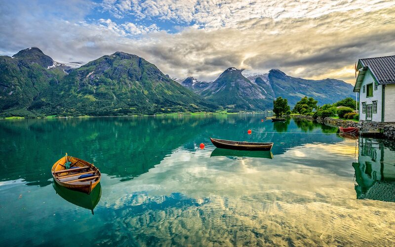 Wooden Boats on Lake — Green, Serene, Sunset