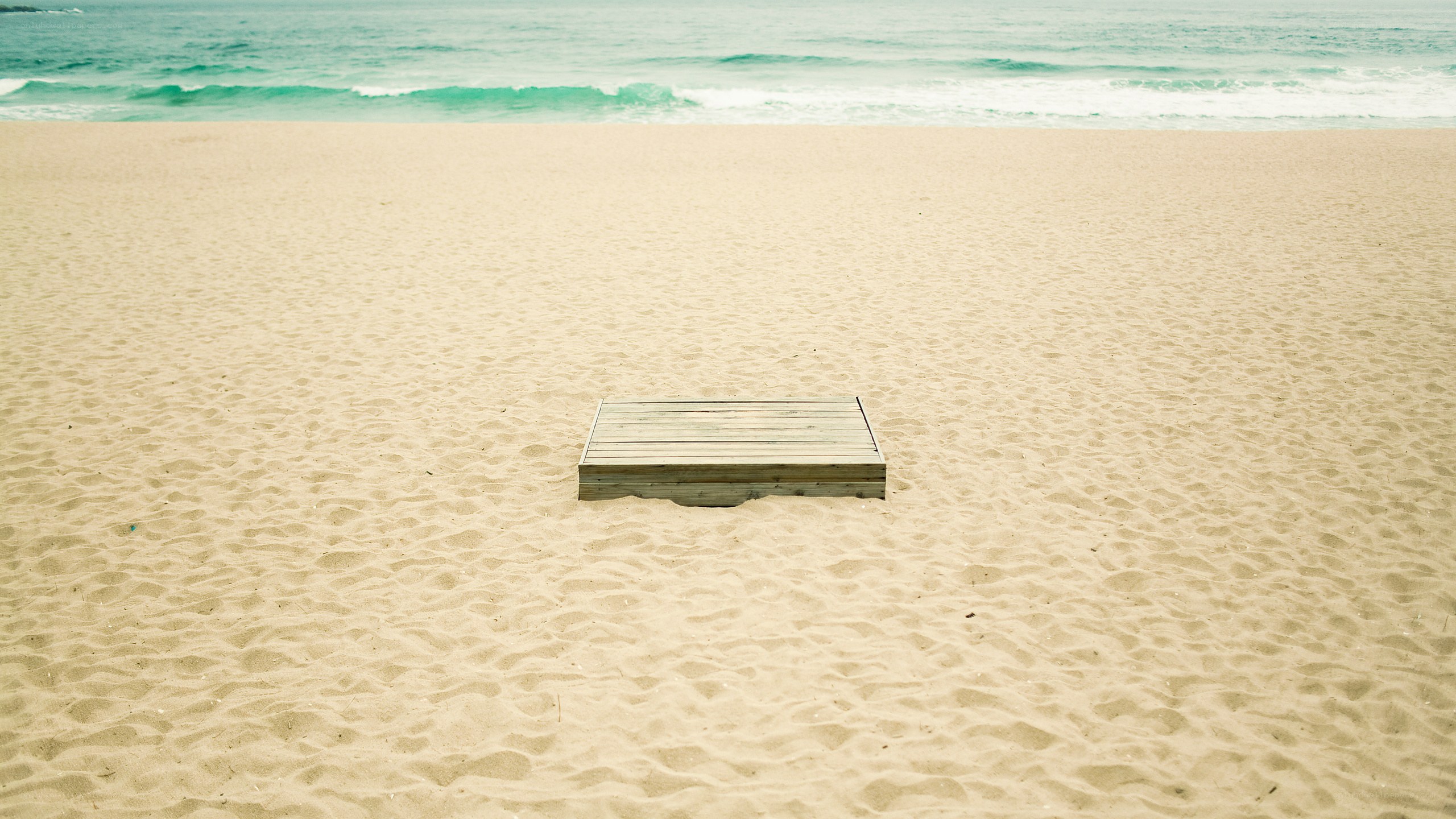 Wooden box on empty beach