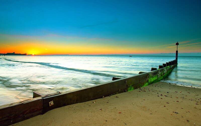 Wooden Breakwater at Sunset — Blue