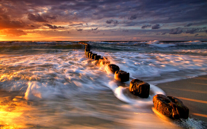 Wooden Breakwater at Sunset — Orange, Dramatic