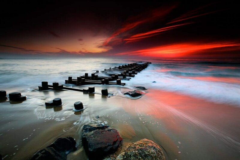 Wooden Breakwater at Sunset — Red