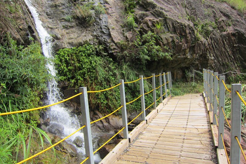 Wooden Bridge Near Waterfall — Brown