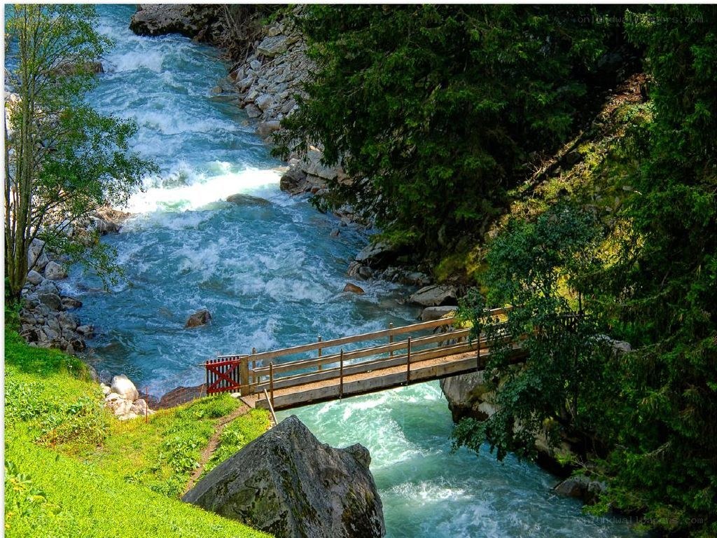 Wooden bridge over a rushing river
