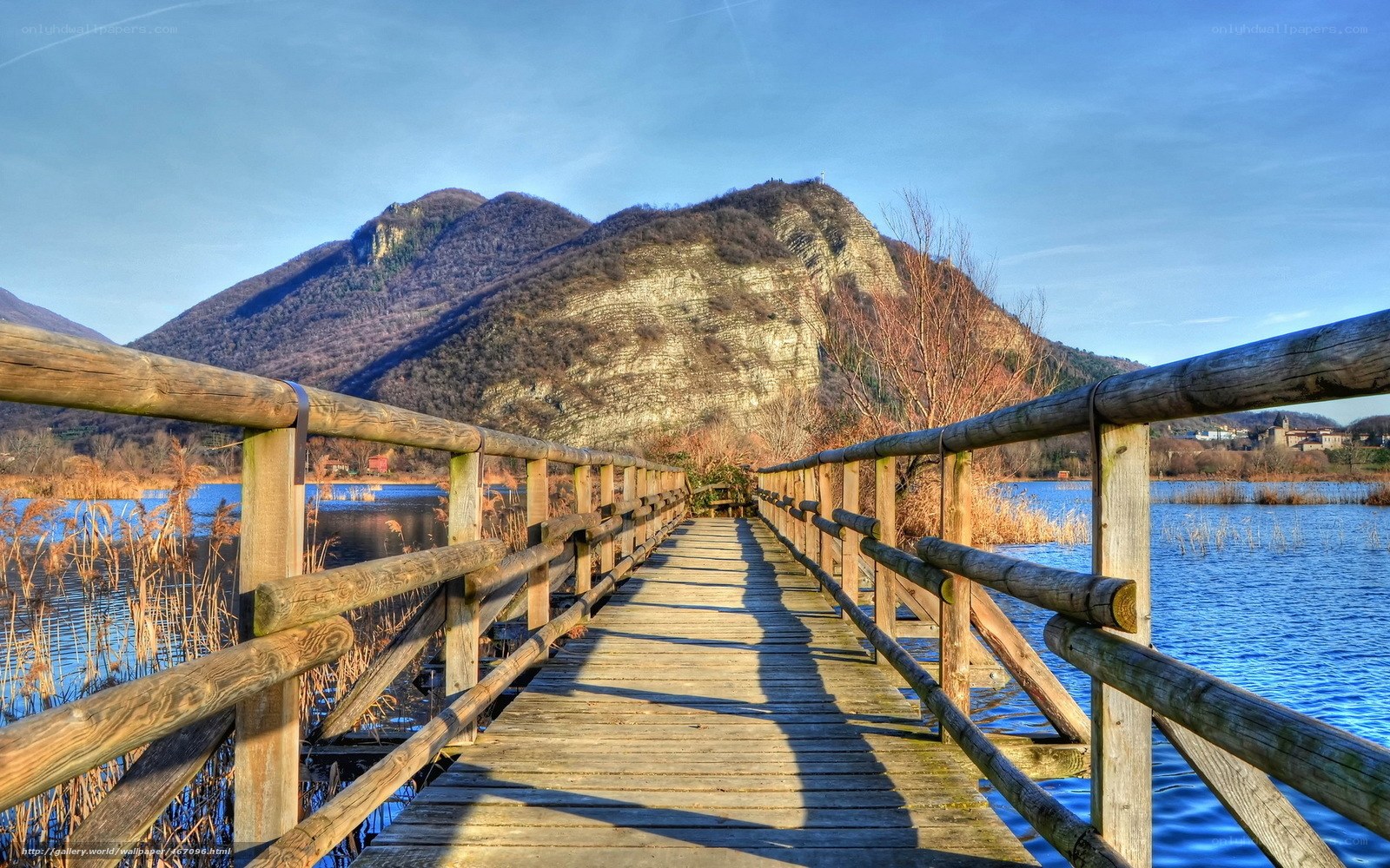 Wooden bridge over lake with mountain