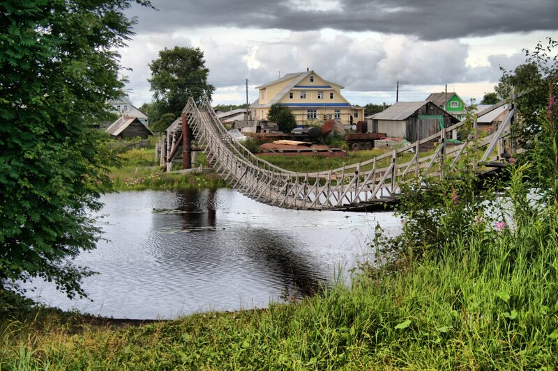 Wooden bridge over river in village