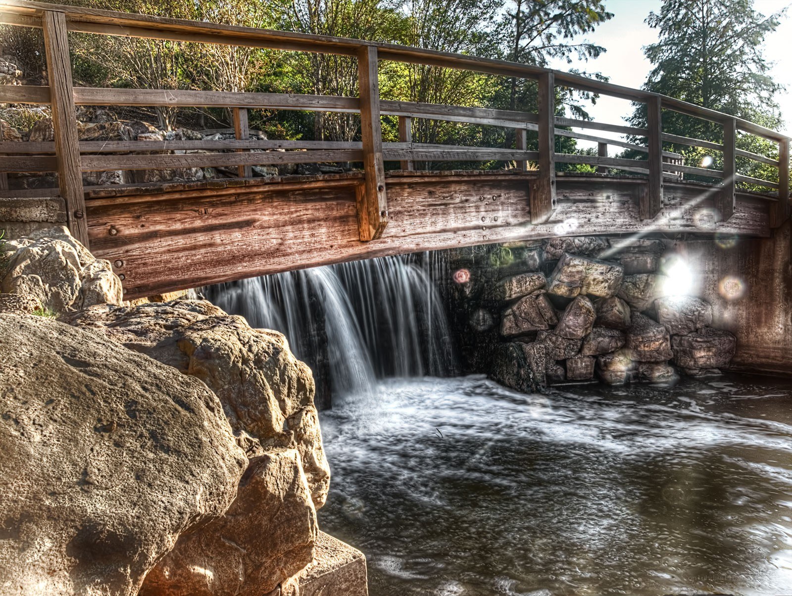 Wooden bridge over waterfall