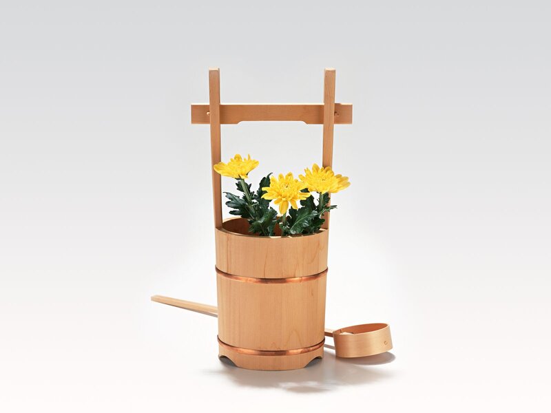 Wooden bucket with yellow flowers