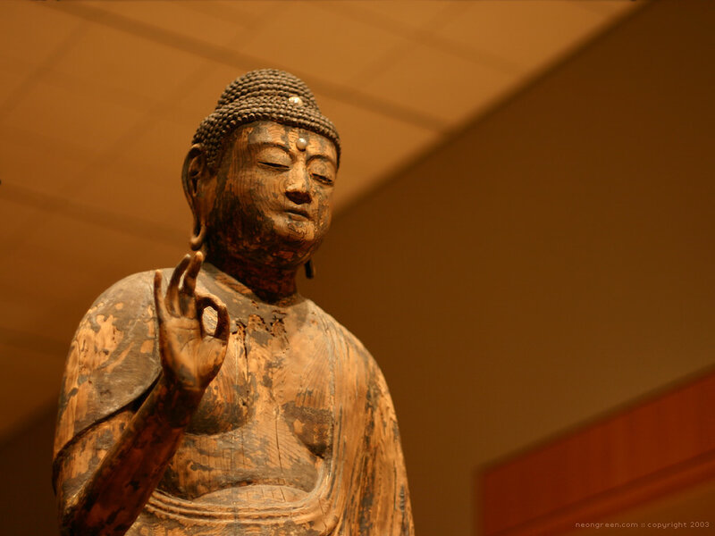 Wooden Buddha statue in gallery