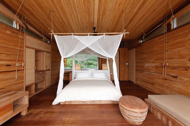 wooden cabin bedroom with canopy bed