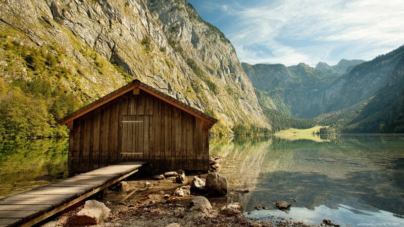 Wooden cabin by a mountain lake