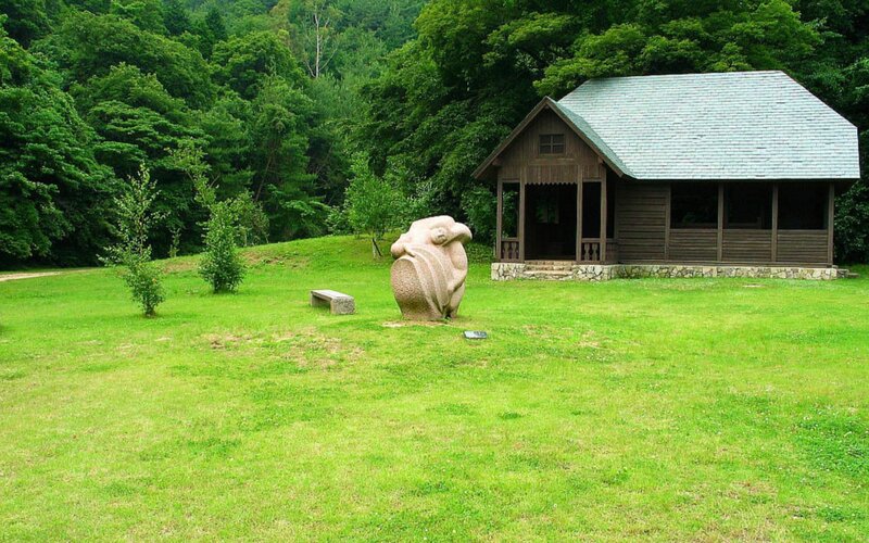 Wooden cabin in a green park