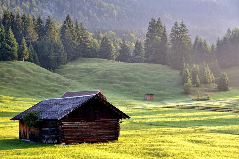 Wooden cabin in a green valley