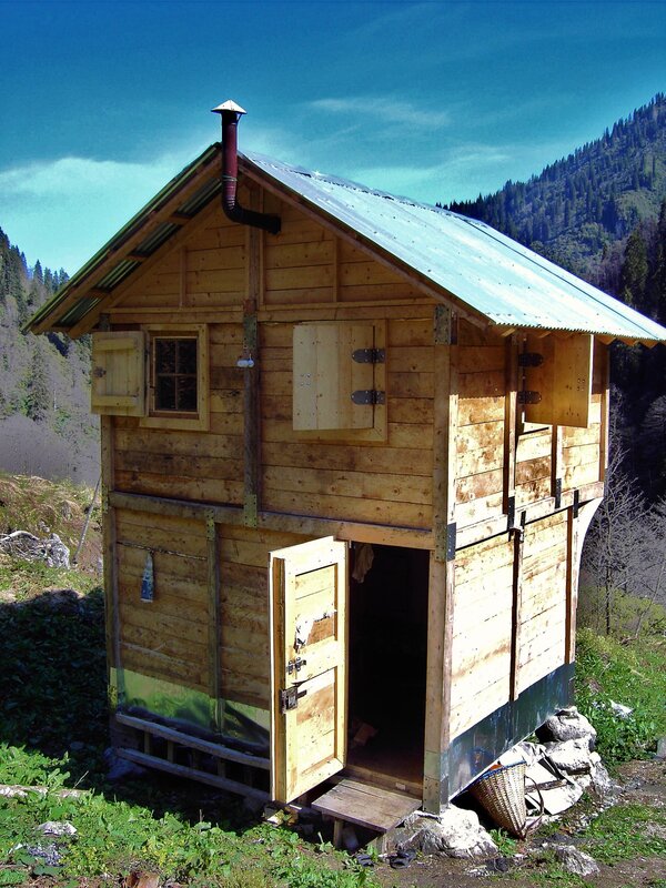 Wooden cabin in mountain valley