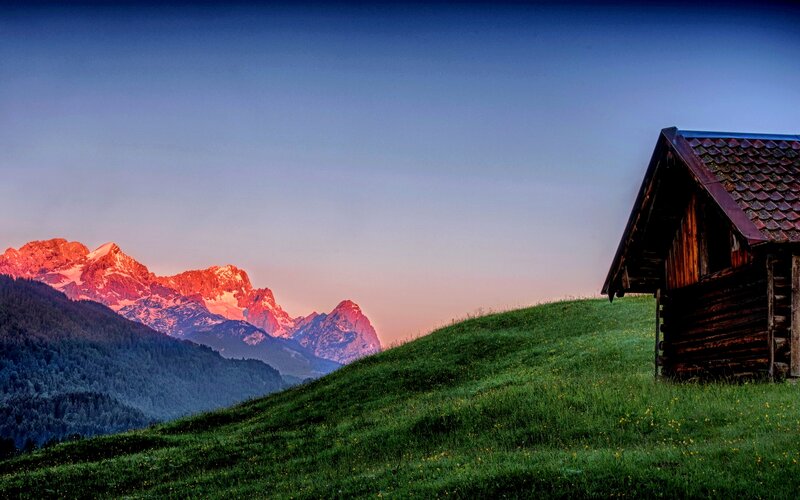 Wooden Cabin in Mountains — Green, Serene, Sunset