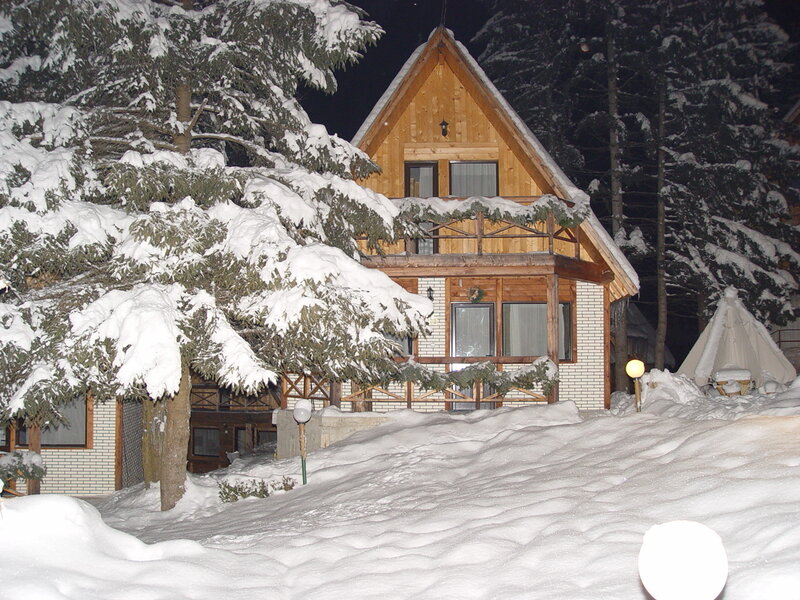 Wooden Cabin in Snow