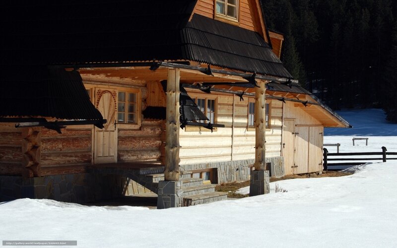 wooden cabin in snowy landscape