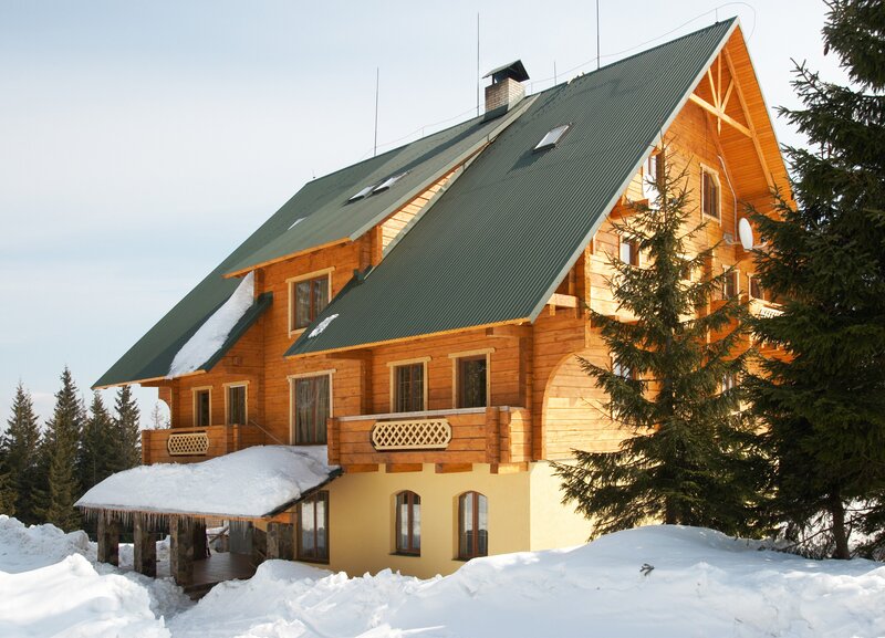 wooden cabin in snowy mountains