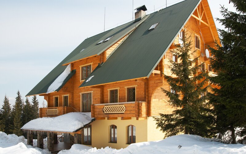 wooden cabin in snowy mountains
