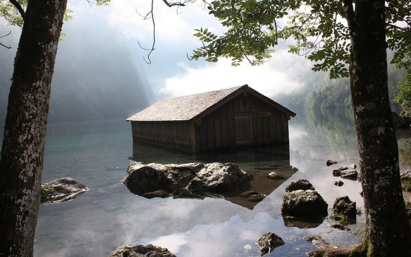 Wooden cabin on a misty lake
