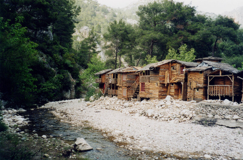 Wooden cabins by a river