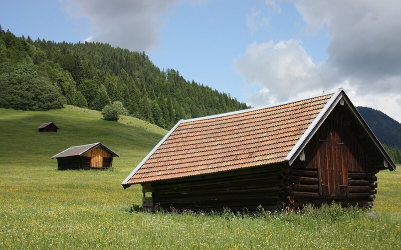Wooden cabins in a green valley