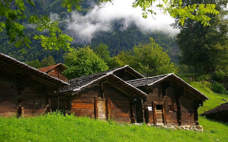 Wooden cabins in a mountain valley