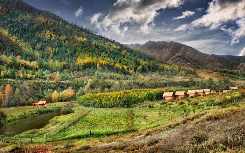 Wooden Cabins in Valley — Green, Dramatic