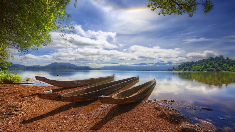 Wooden Canoes on Shore — Blue, Serene, Afternoon, Photograph